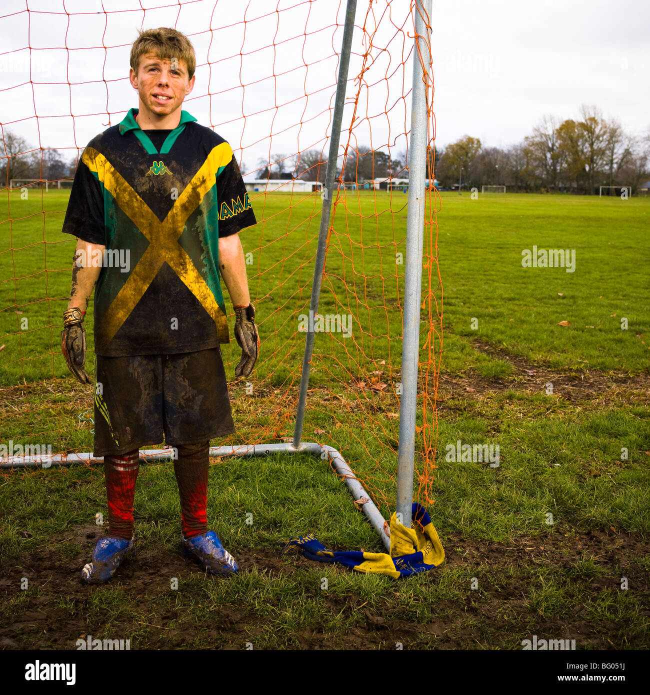 Two dirty teenagers standing in goal mouth after football/soccer  practice, Cambridge New Zealand Stock Photo