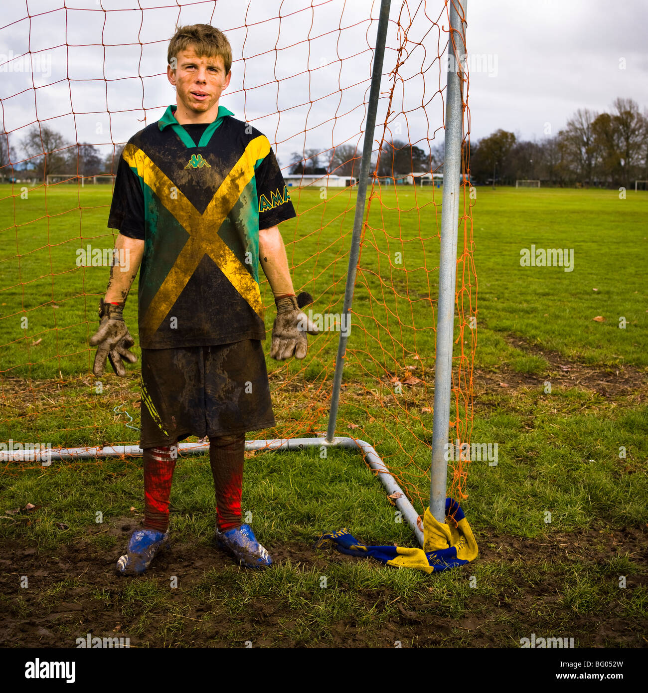 Two dirty teenagers standing in goal mouth after football/soccer  practice, Cambridge New Zealand Stock Photo