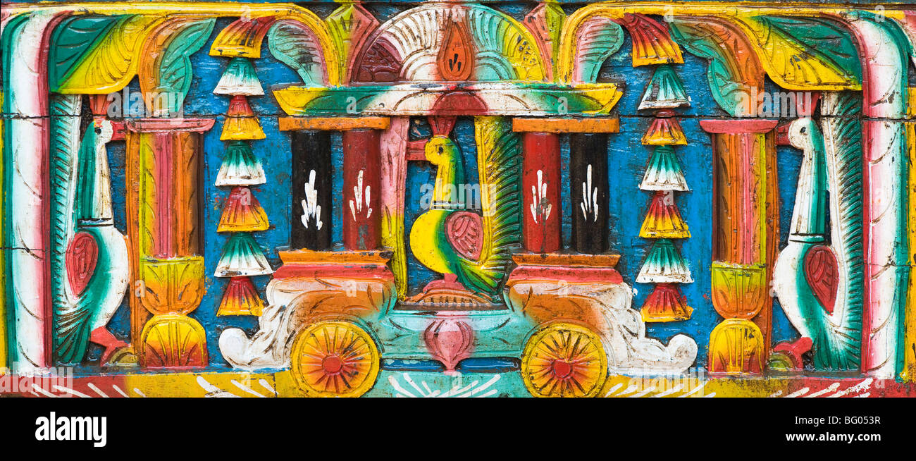 Colourful Indian wooden carving on the back of a bullock cart. India Stock Photo