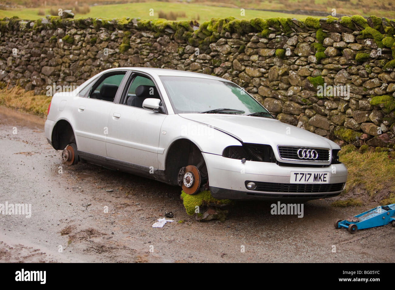 a car that had its wheels stolen after being abandoned in the floods on kirkstone pass above Ambleside, Lake district, Stock Photo
