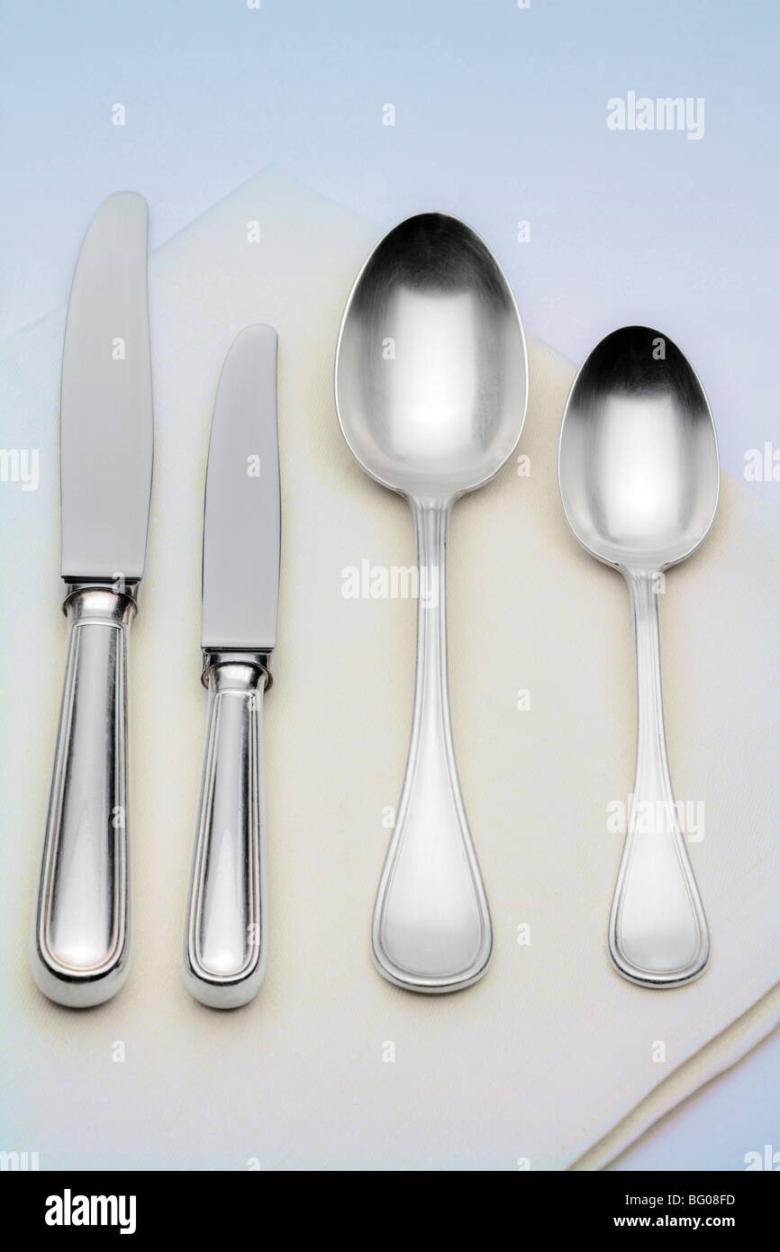 elegant table setting with silverware on white cloth Stock Photo - Alamy
