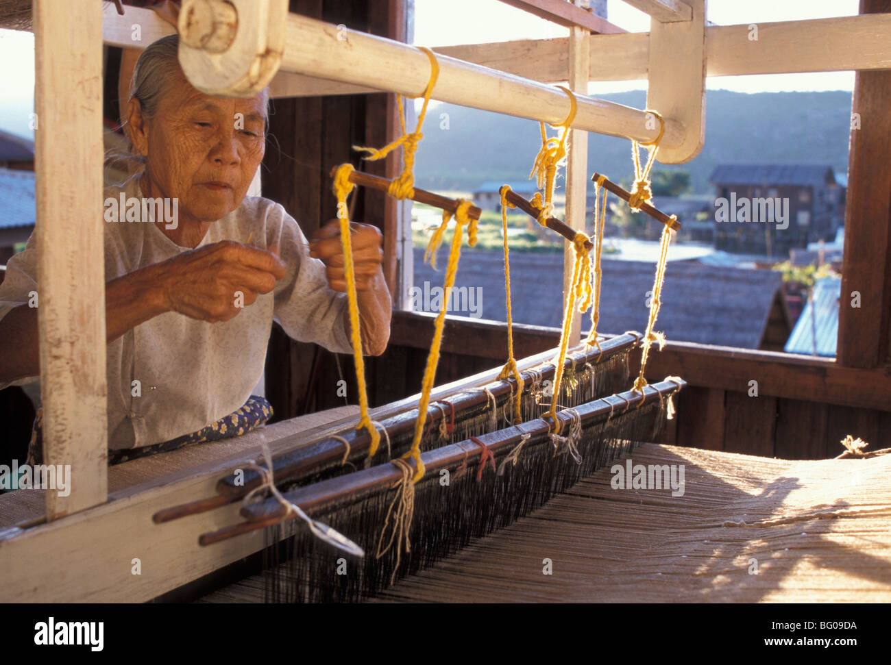 Weaver with her loom, Inle Lake, Shan State, Myanmar (Burma), Asia Stock Photo