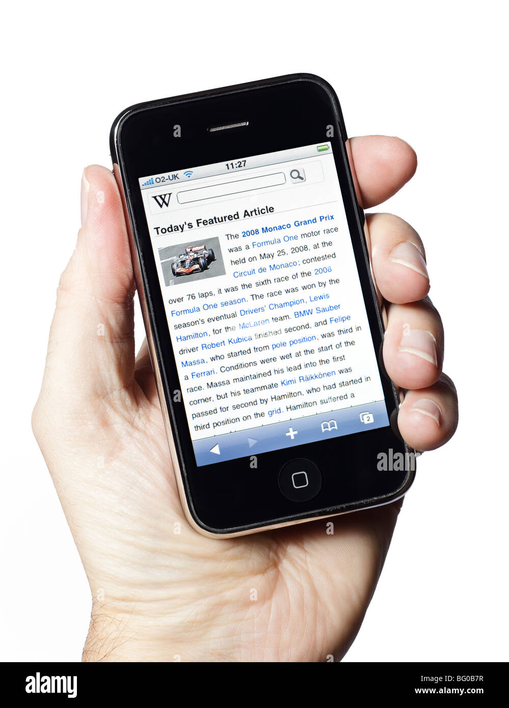 Male hand holding iPhone showing Wikipedia application on white background Stock Photo