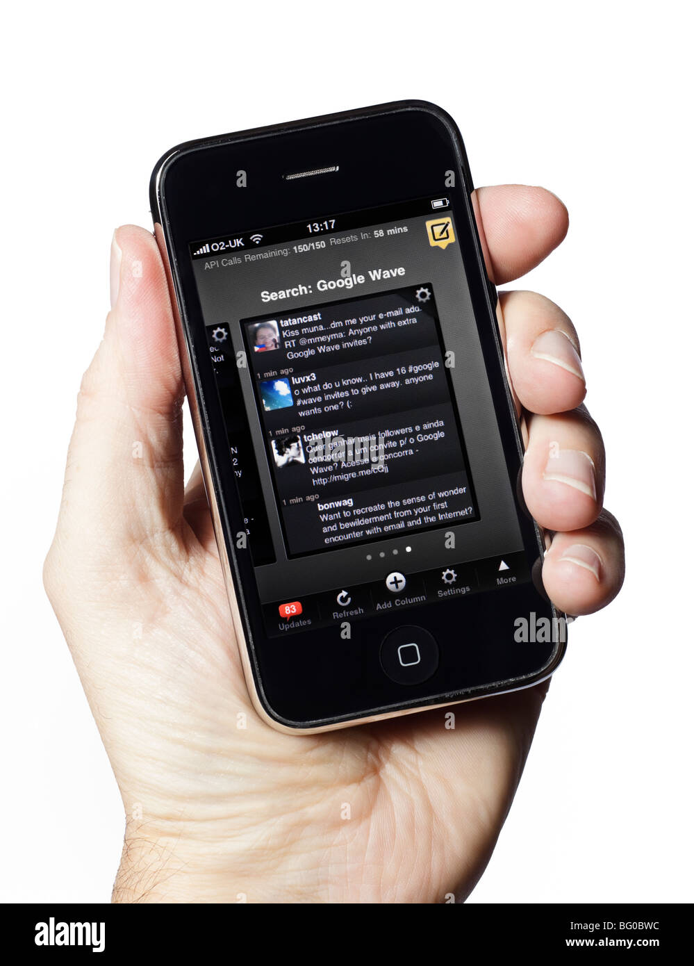 Male hand holding iPhone using Tweetdeck Twitter application Stock Photo