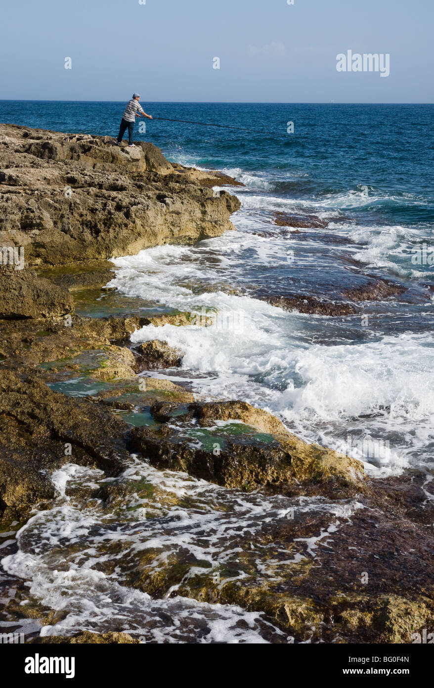 Sea and foam on rocks Stock Photo - Alamy