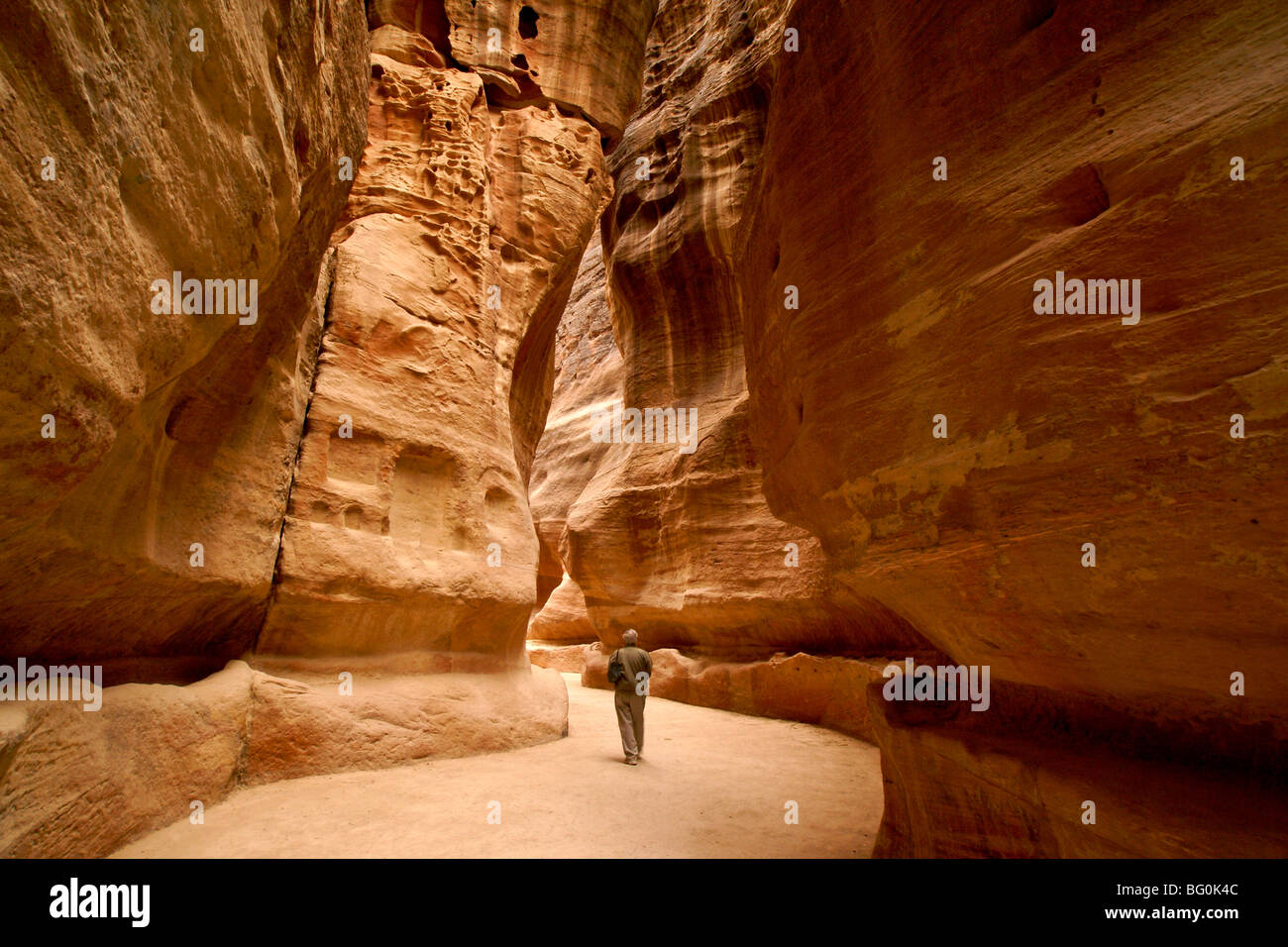 Tourist walking through the Siq, Petra, Jordan Stock Photo
