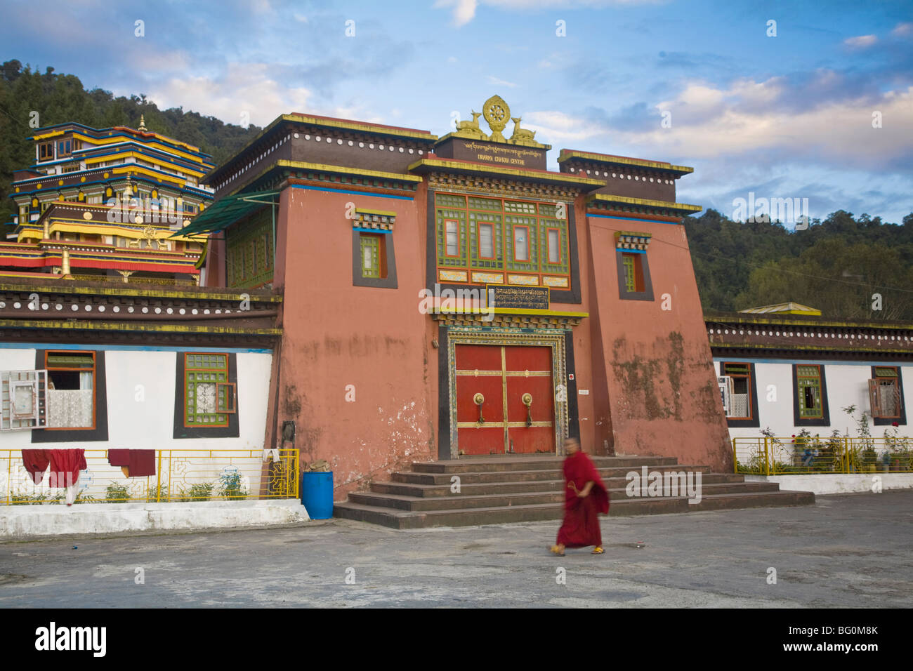 Monk walking past entrance to main monastery building, Rumtek Gompa Complex, Gangtok, Sikkim, India, Asia Stock Photo