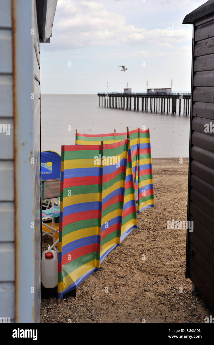 felixstowe pier beach huts and wind break on beach Stock Photo