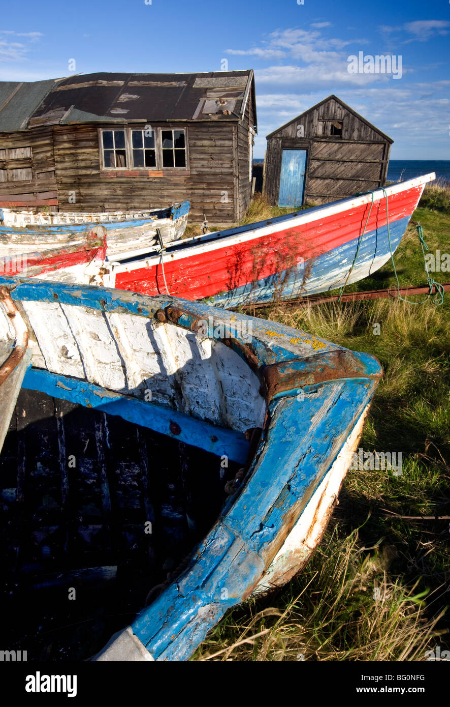 Old fishing boats and delapidated fishermens huts, Beadnell, Northumberland, England, United Kingdom, Europe Stock Photo