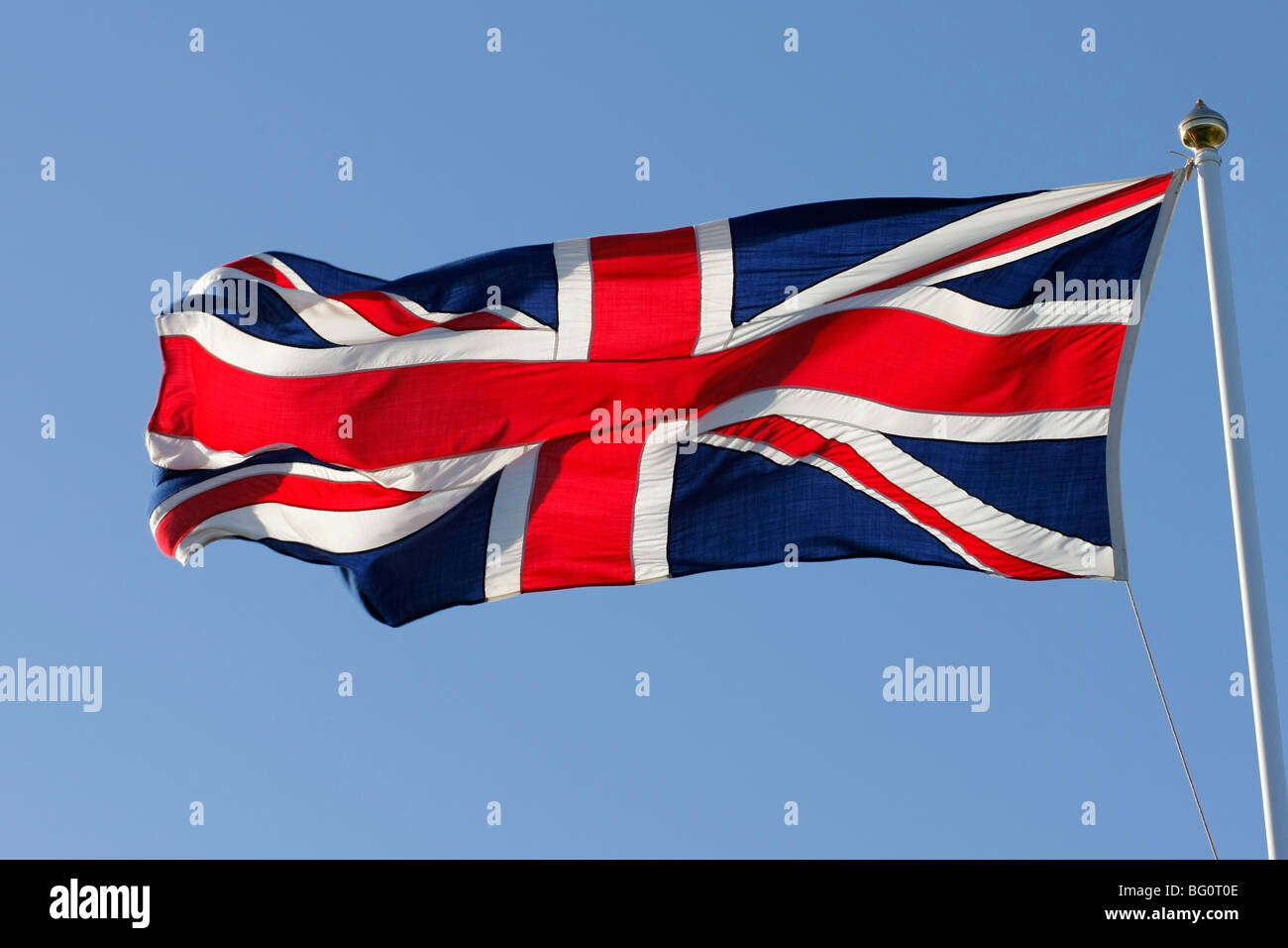 Union Jack flag against blue sky Stock Photo - Alamy