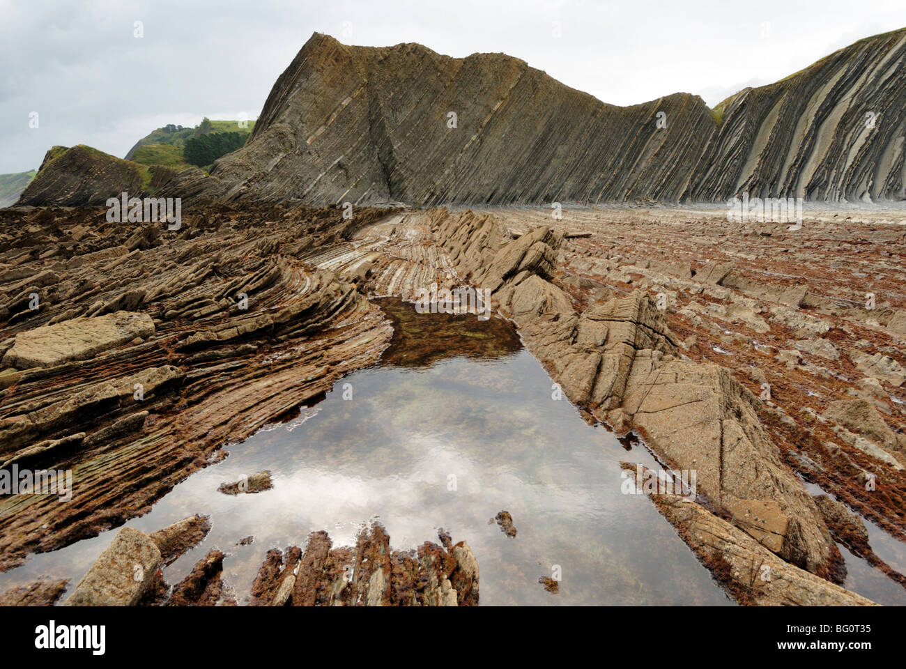 Rock formations (flysch) at low tide on coast between Zumaia and Deba, Costa Vasca, Basque country, Euskadi, Spain, Europe Stock Photo