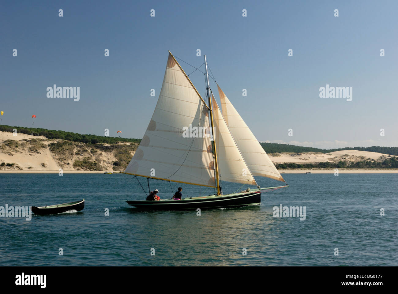 Od gaff rigged sailing yacht and dinghy, sailing along Dune du Pyla