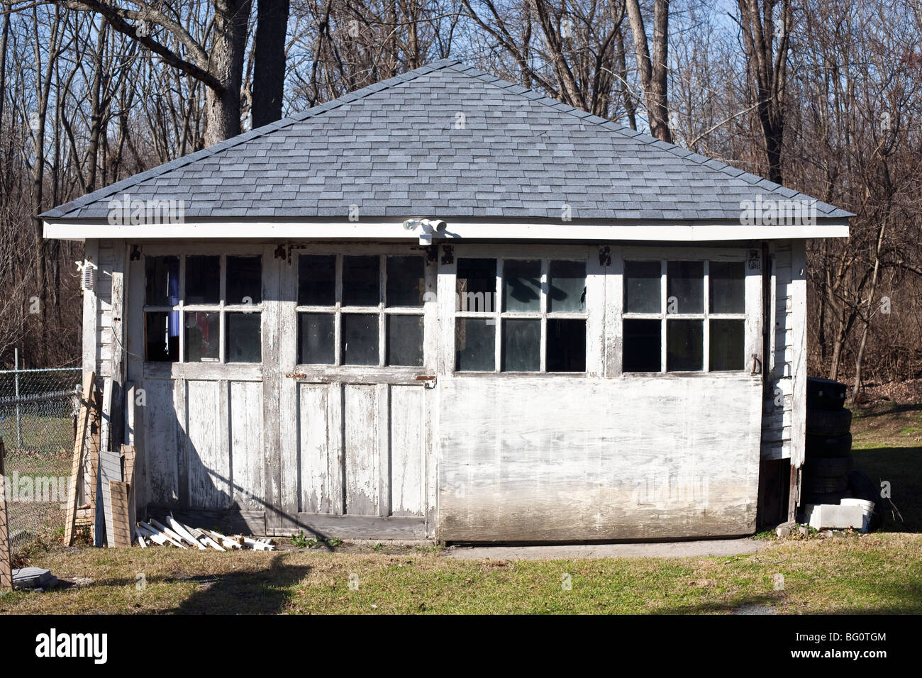 View Of Old Wooden Garage With Flaking White Paint A Brand New