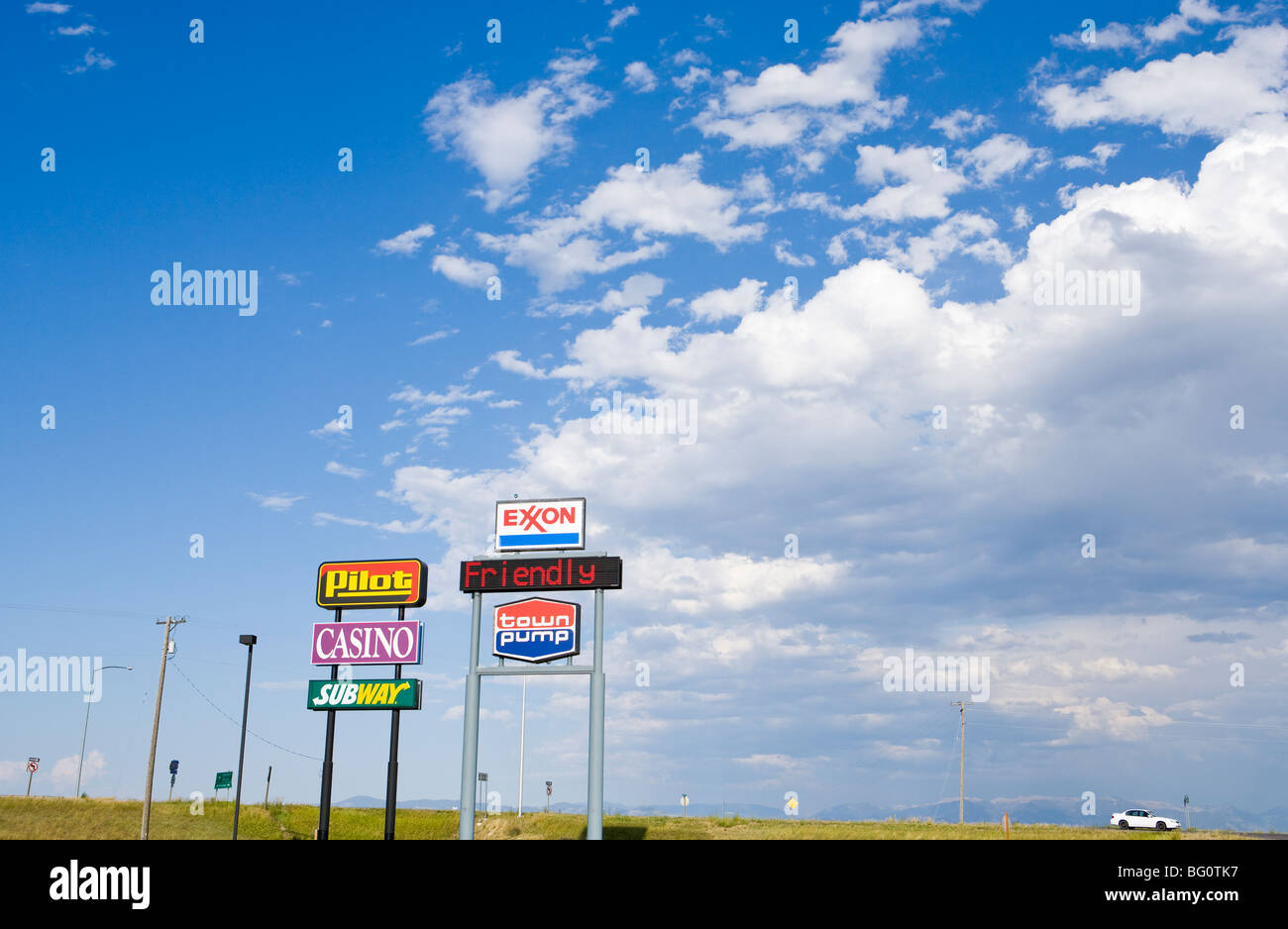 Service station signs and sky along Interstate Highway 90 in Southwestern Montana. Stock Photo