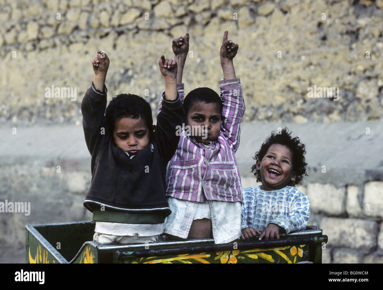 Three children act up for the camera in Cairo, Egypt Stock Photo