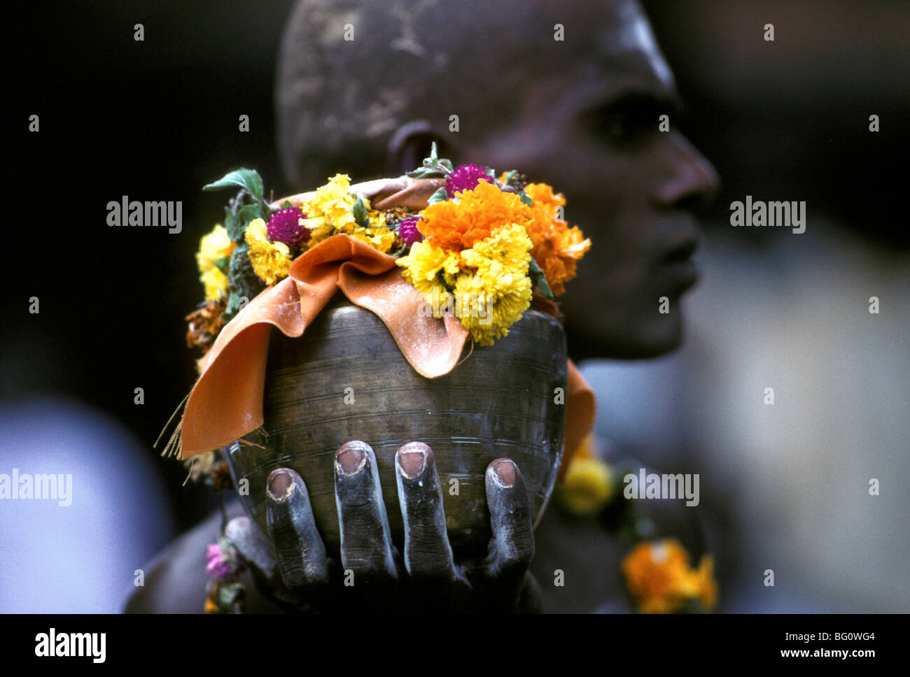 A pilgrim/devotee brings an offering to the Palani Murugan Temple and is taking part in the Thaipusam festival to honor Lord Subramaniam (also known as Lord Muruga), son of Shiva. Thousands of Hindus like this man come to seek penance and absolution for past sins and show gratitude to God for blessings during the year Stock Photo