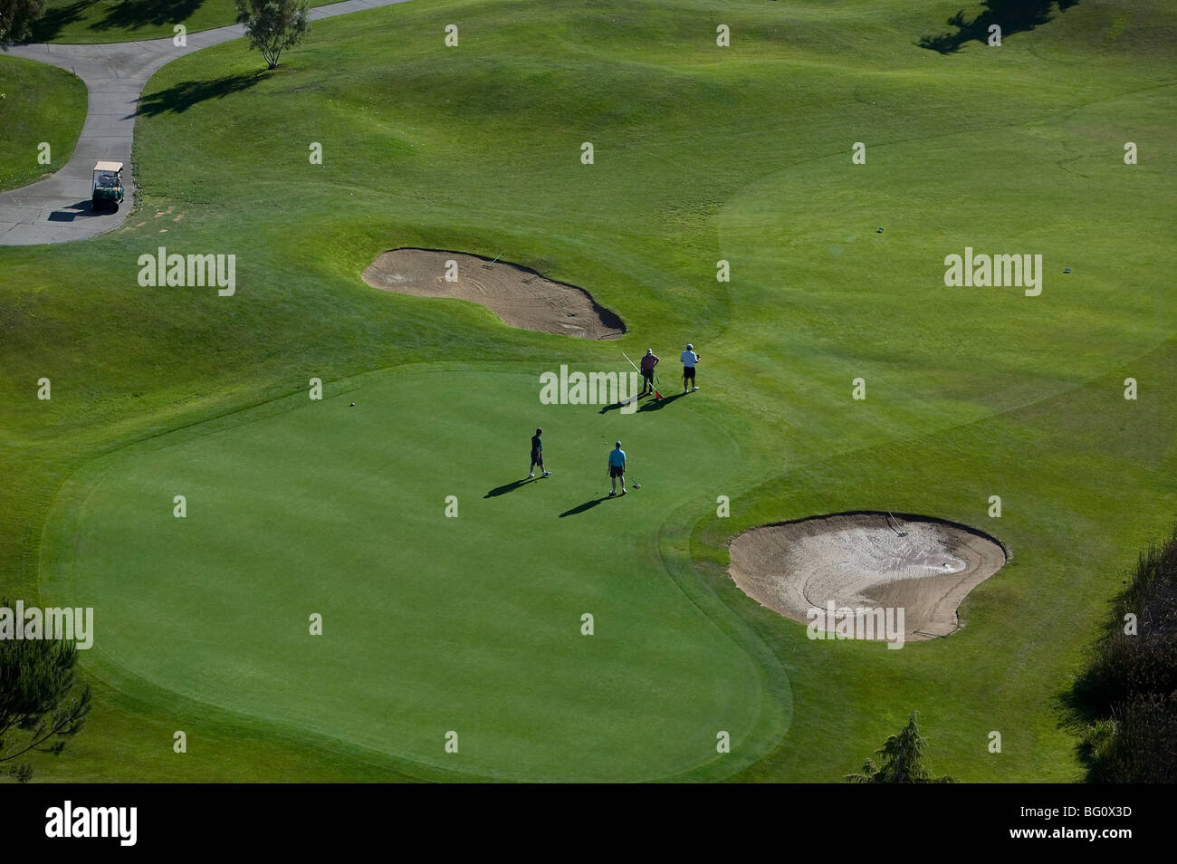 aerial above four golfers putting on green Rooster Run golf course Petaluma California Sonoma County Stock Photo