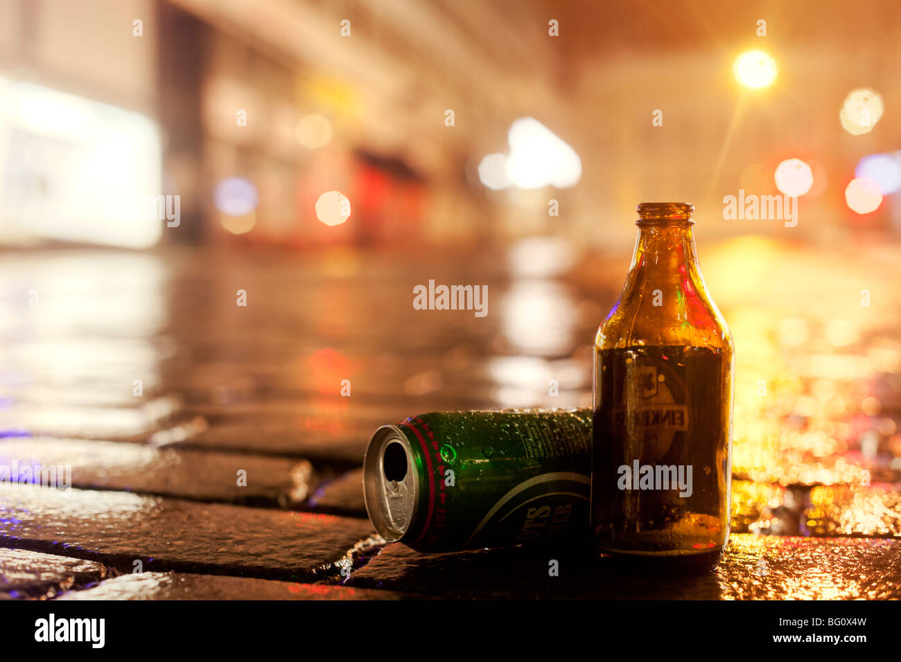 Empty beer containers on wet street Stock Photo