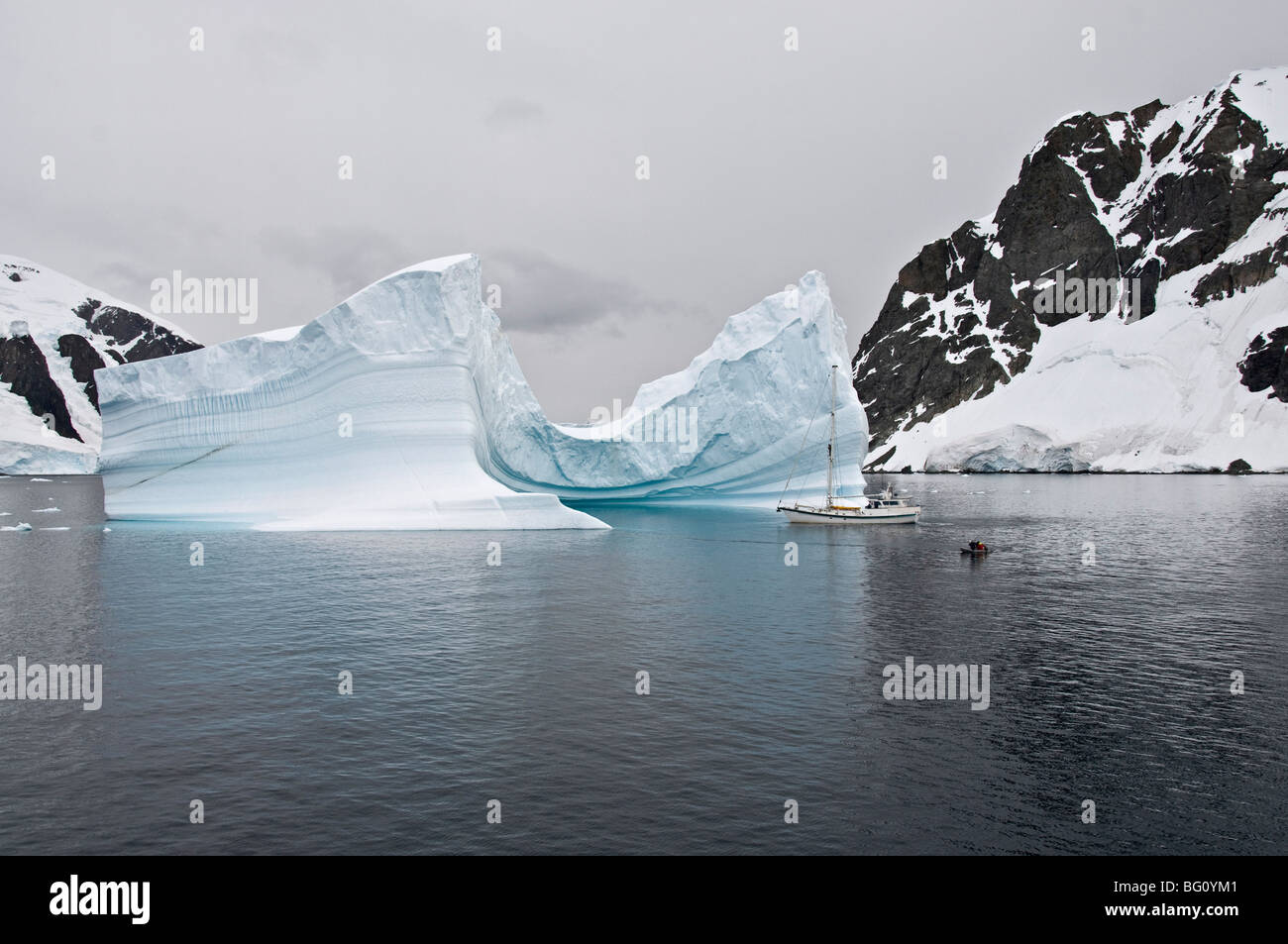 Sailing yacht and iceberg, Errera Channel, Antarctic Peninsula, Antarctica, Polar Regions Stock Photo