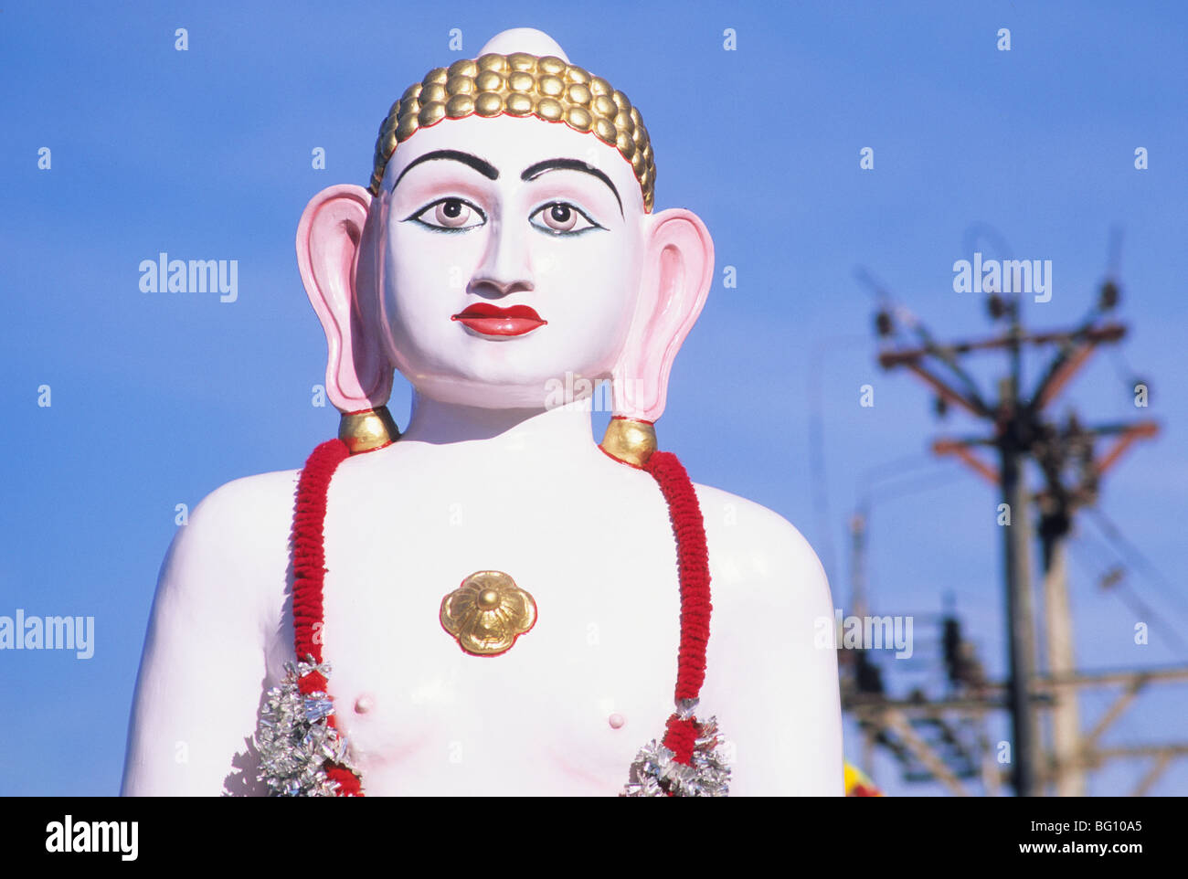 A large Buddah with a electrical and telephone lines in the background in Ooty, India Stock