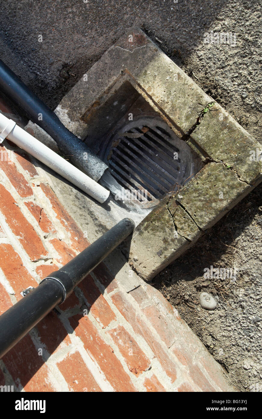 Domestic water pipes leading to a drain Stock Photo
