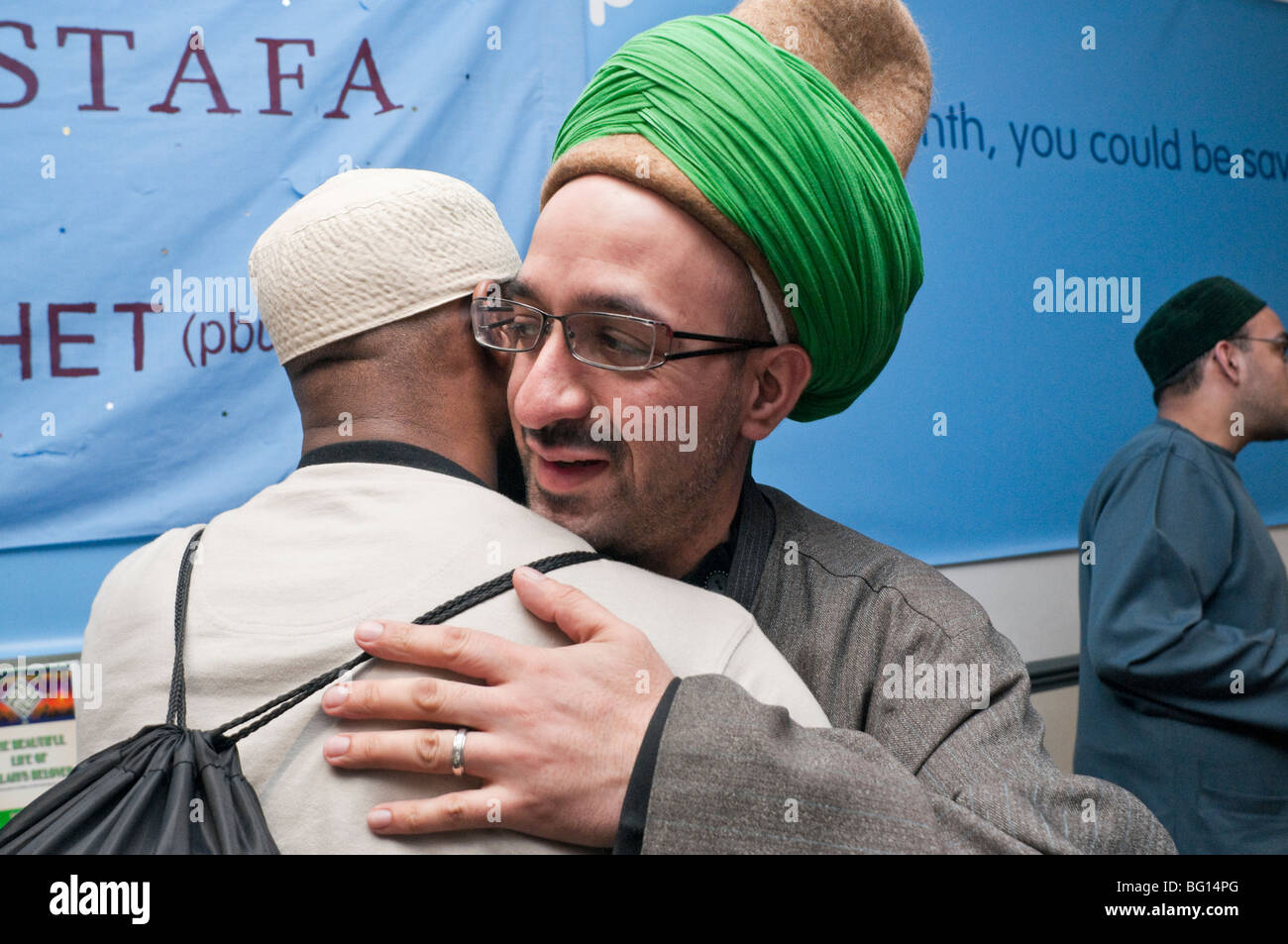Men greet each other at Eid Milad-Un-Nabi Celebrations at Sunni Muslim Association, Tooting, London. Stock Photo