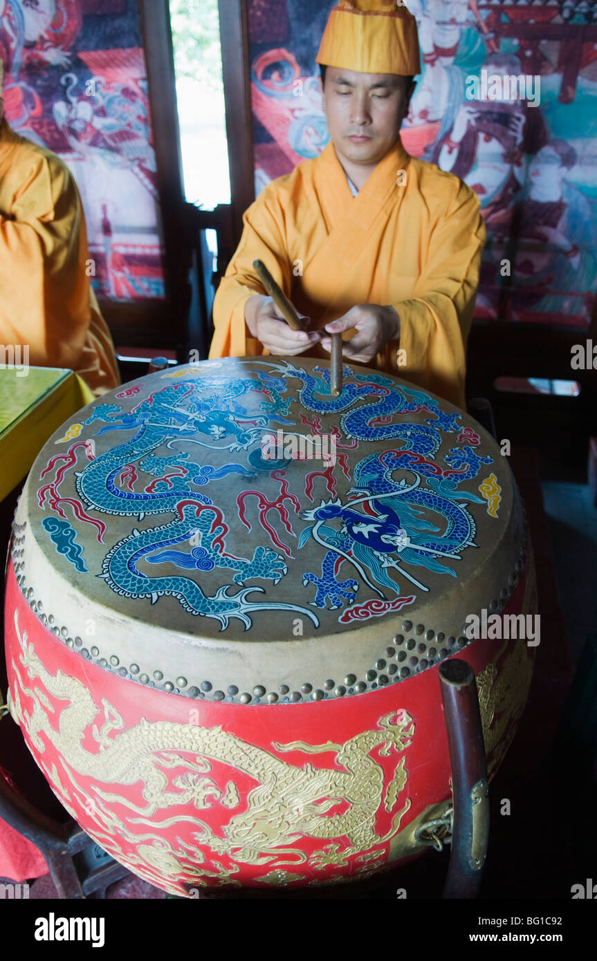 Musician playing a painted drum in Zhihua temple, a Ming Dynasty era Buddhist temple, Beijing, China, Asia Stock Photo