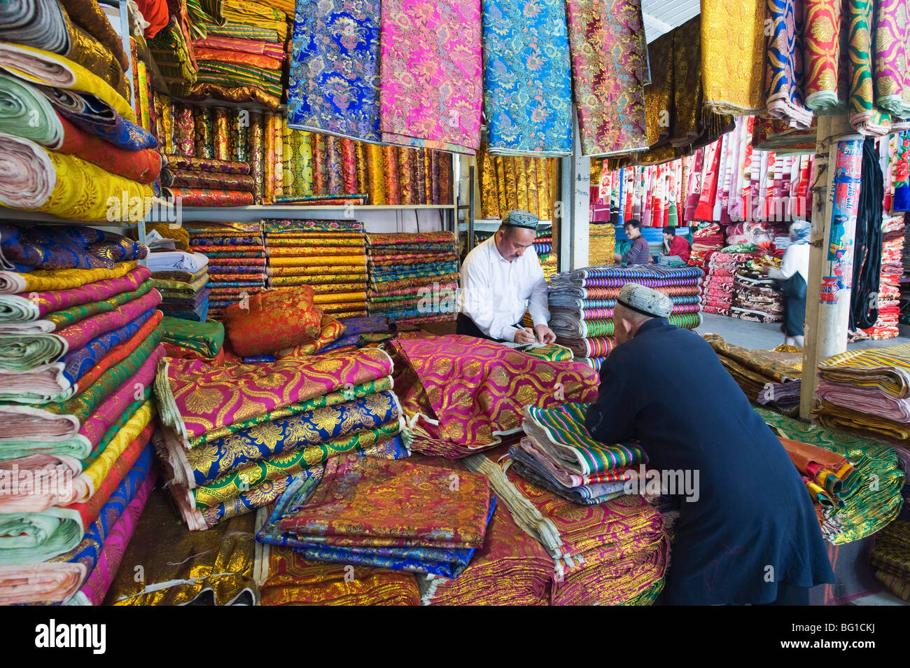 Silk fabrics being sold at the Sunday market, Kashgar (Kashi), Xinjiang