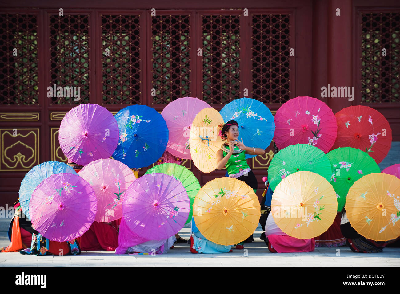 Girls dancing with colourful parasols at the Ethnic Minorities Park, Beijing, China, Asia Stock Photo