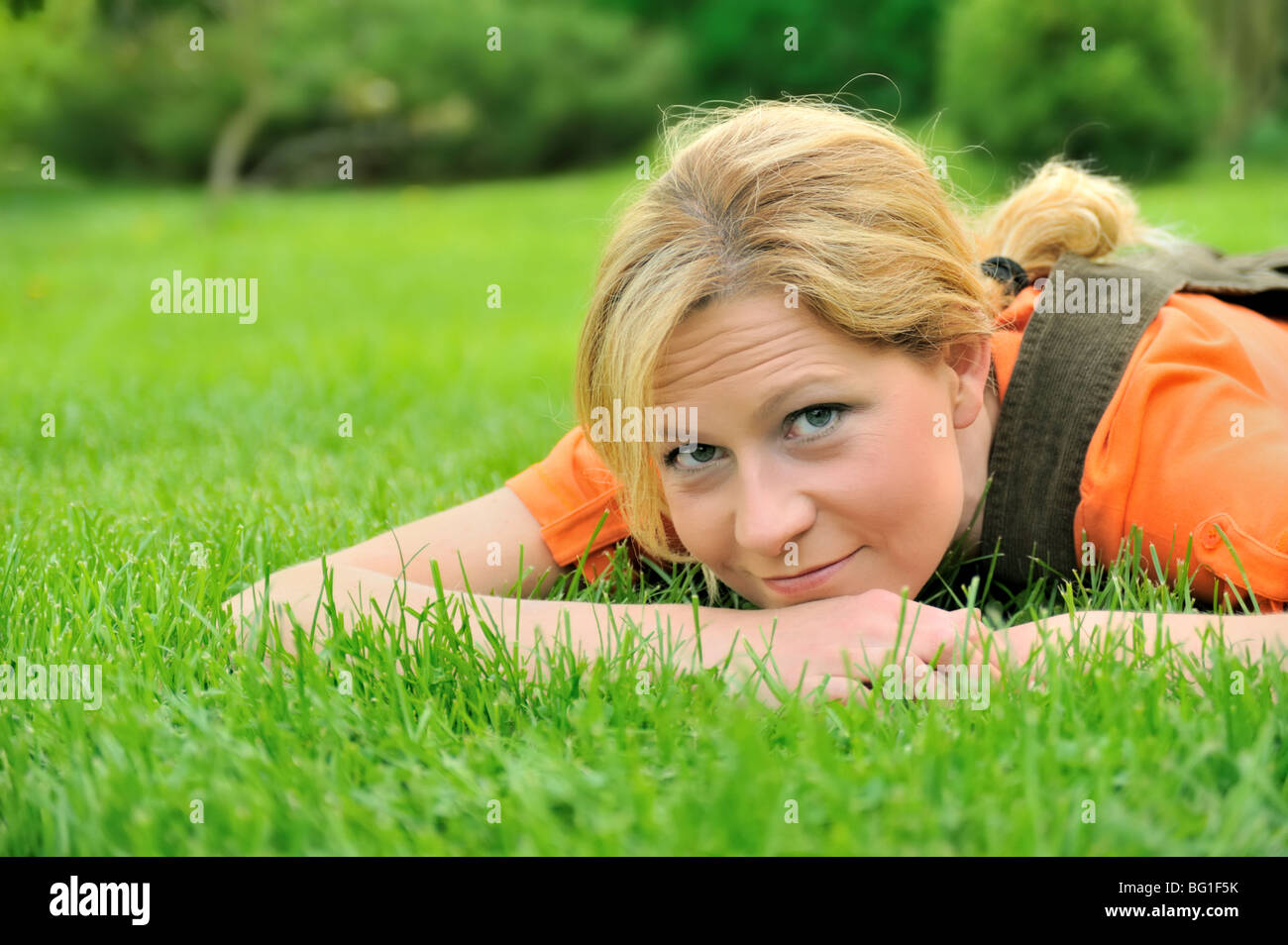 Young woman relaxing on the grass Stock Photo - Alamy