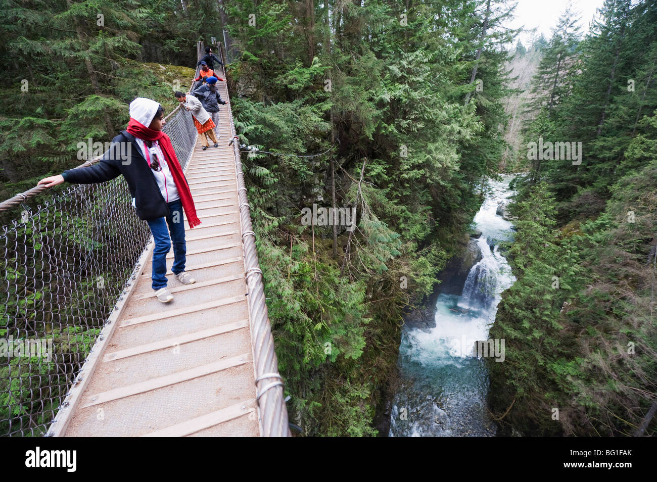 Tourists on a suspension bridge in Lynn Canyon Park, Vancouver, British Columbia, Canada Stock Photo