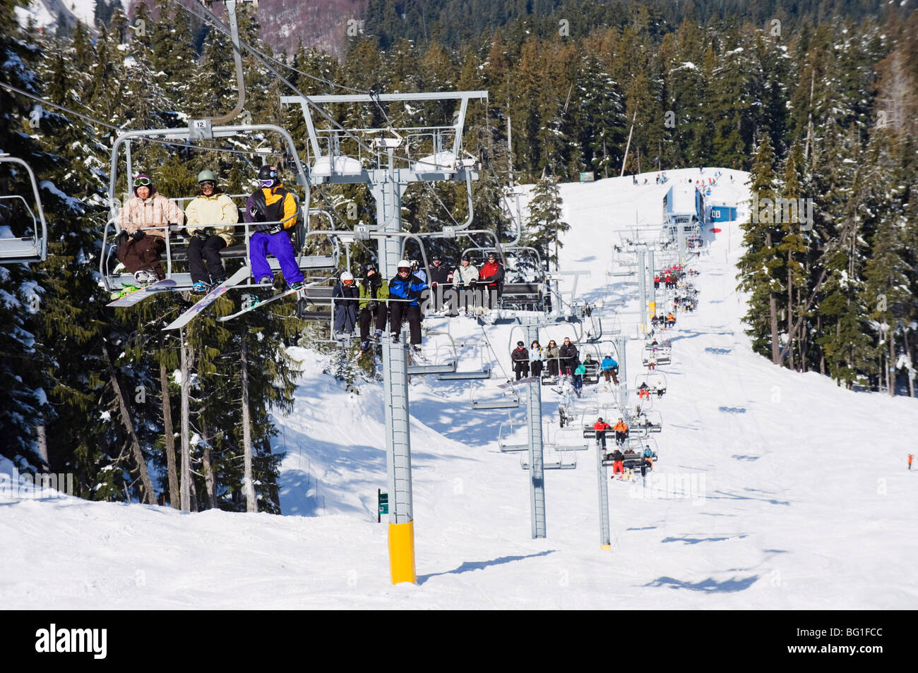 Chairlift with skiers, Whistler mountain resort, venue of the 2010 Winter Olympic Games, British Columbia, Canada, North America Stock Photo