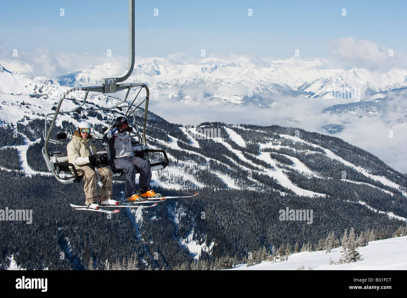 Chairlift with skiers, Whistler mountain resort, venue of the 2010 Winter Olympic Games, British Columbia, Canada, North America Stock Photo