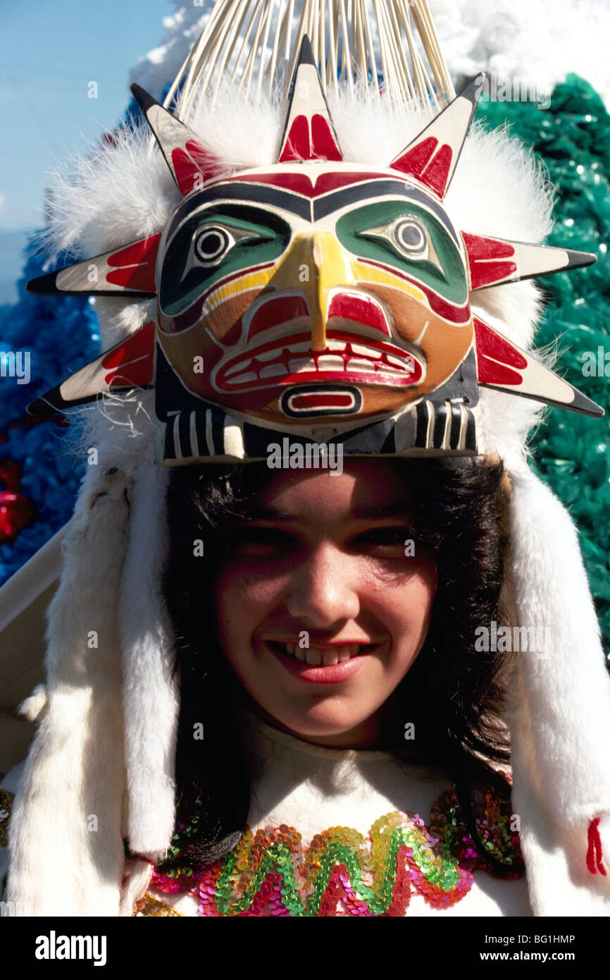 Native American Indian Girl wearing Traditional Ceremonial Mask Headdress and Costume at Pow Wow, British Columbia, BC, Canada Stock Photo