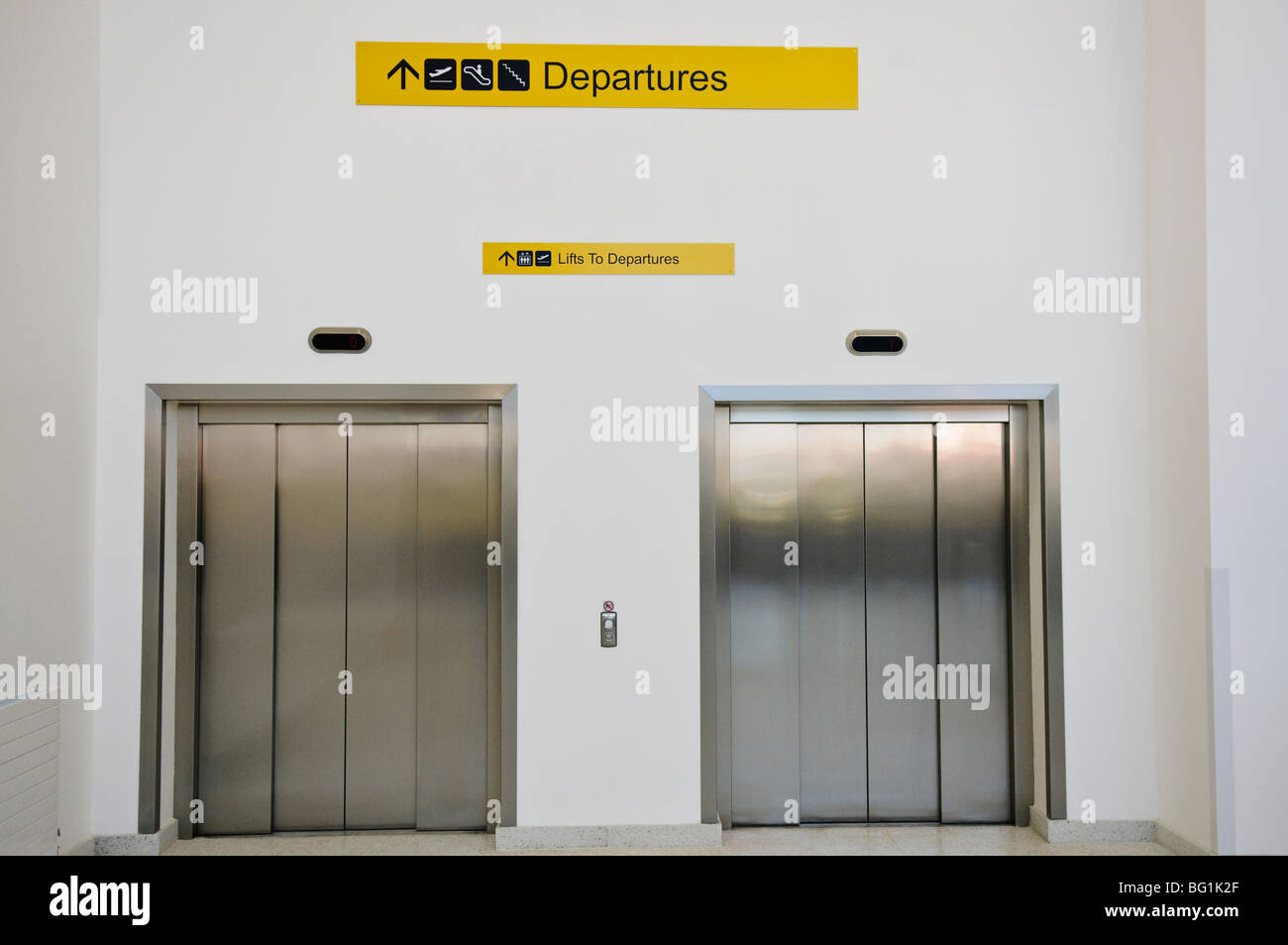 Elevators to departures in an airport Stock Photo