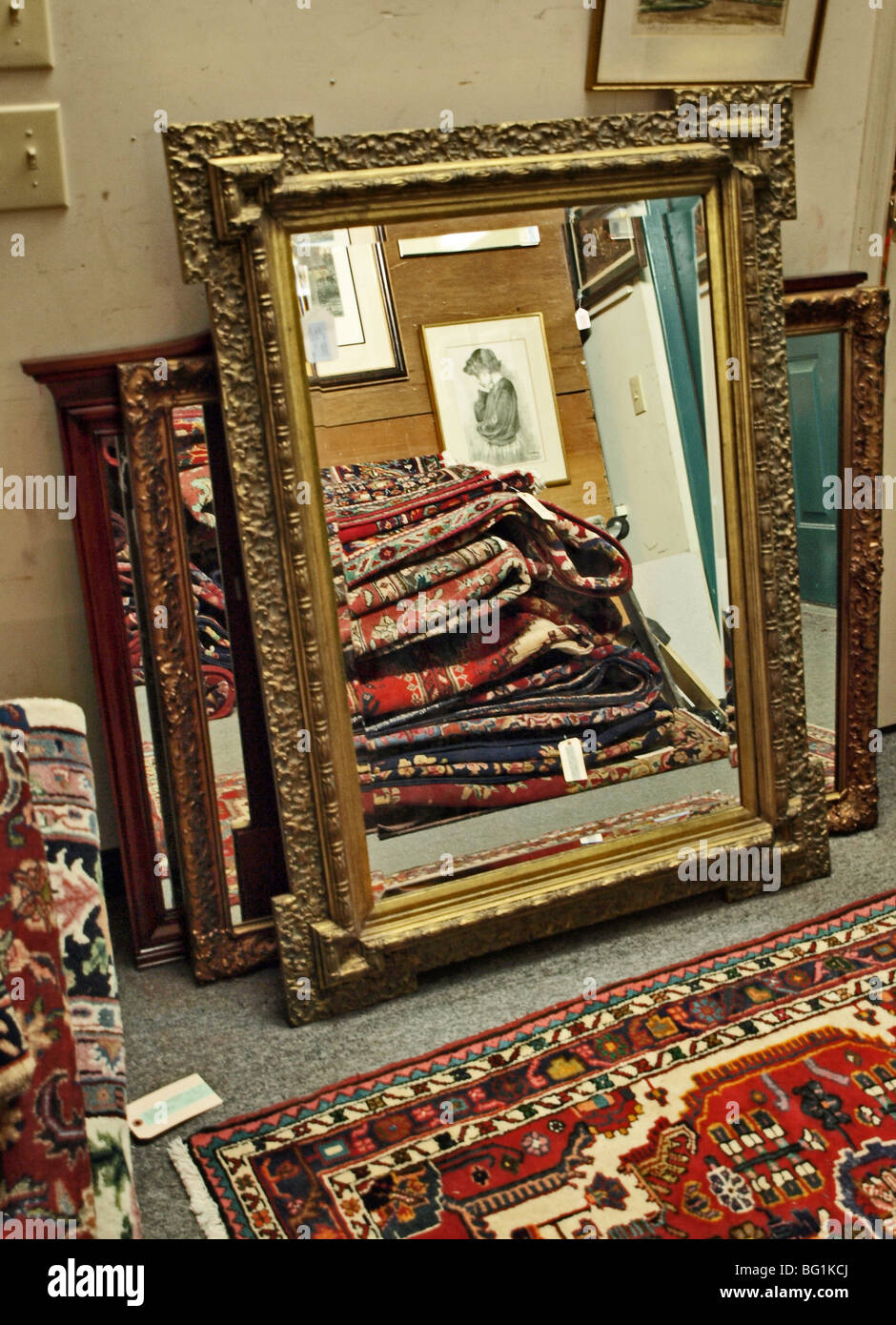 large ornate framed mirror with image of oriental rugs in a pile rug on