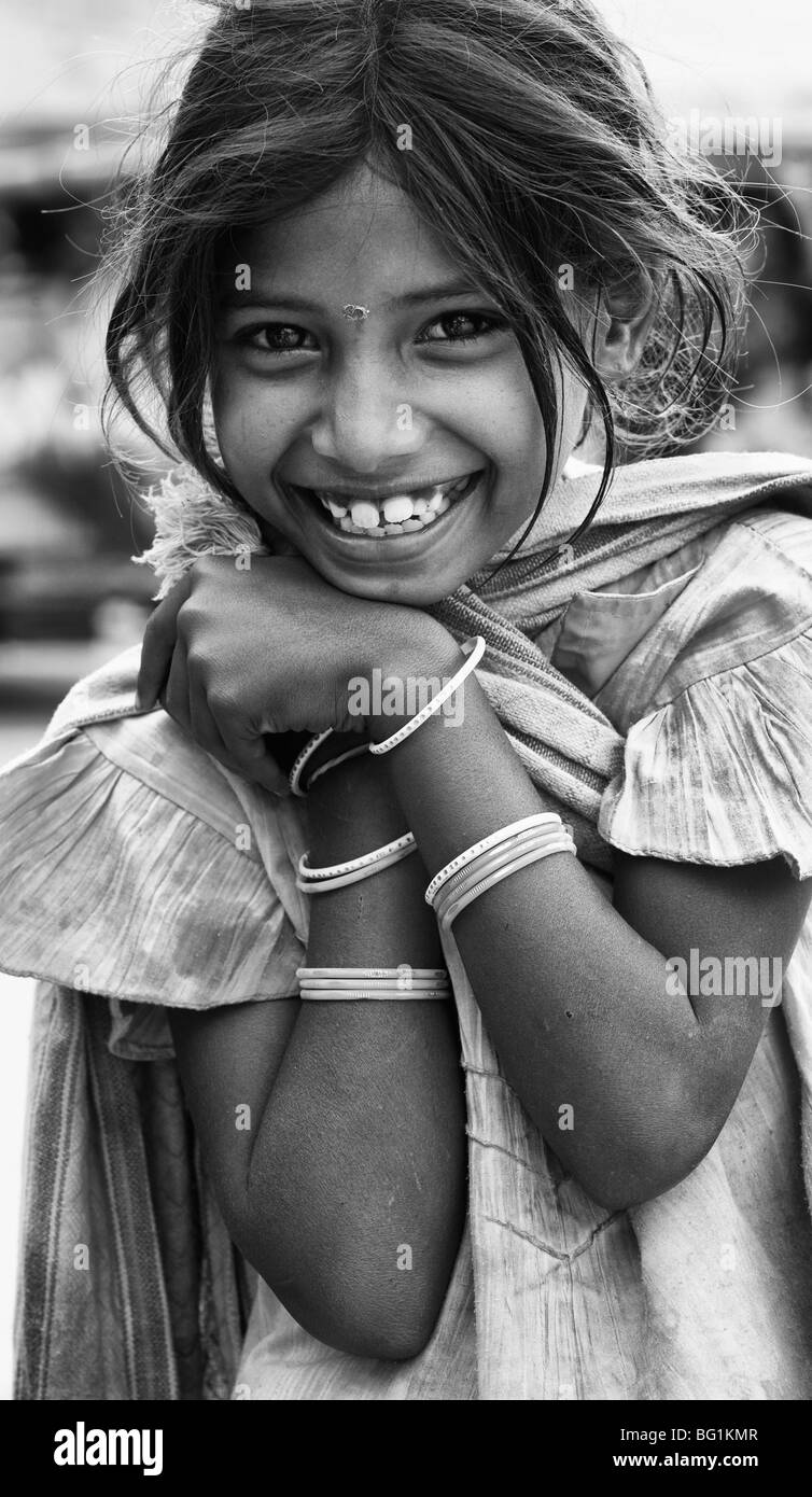 Poor lower caste indian street girl with a beautiful smile. Monochrome Stock Photo