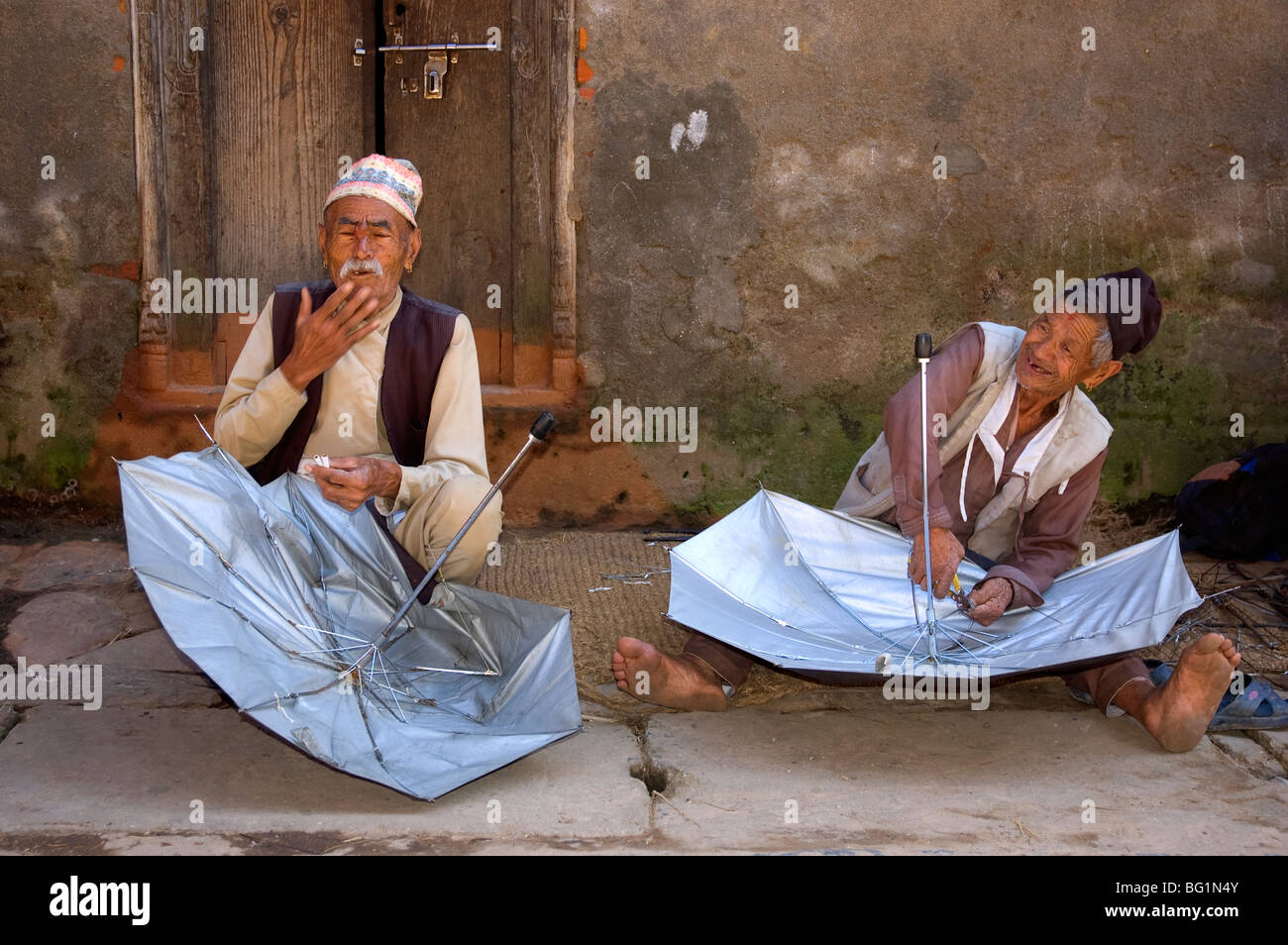 Umbrella repair men at the small village of Bungamati, Nepal Stock Photo -  Alamy