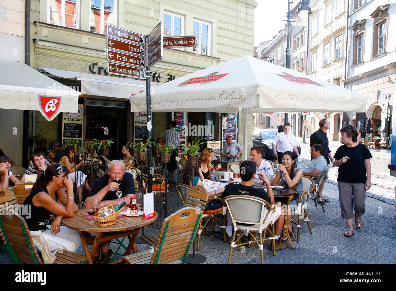 People sitting at an outdoor cafe in Malostranske Namesti Square, Mala Strana, Prague, Czech Republic, Europe Stock Photo