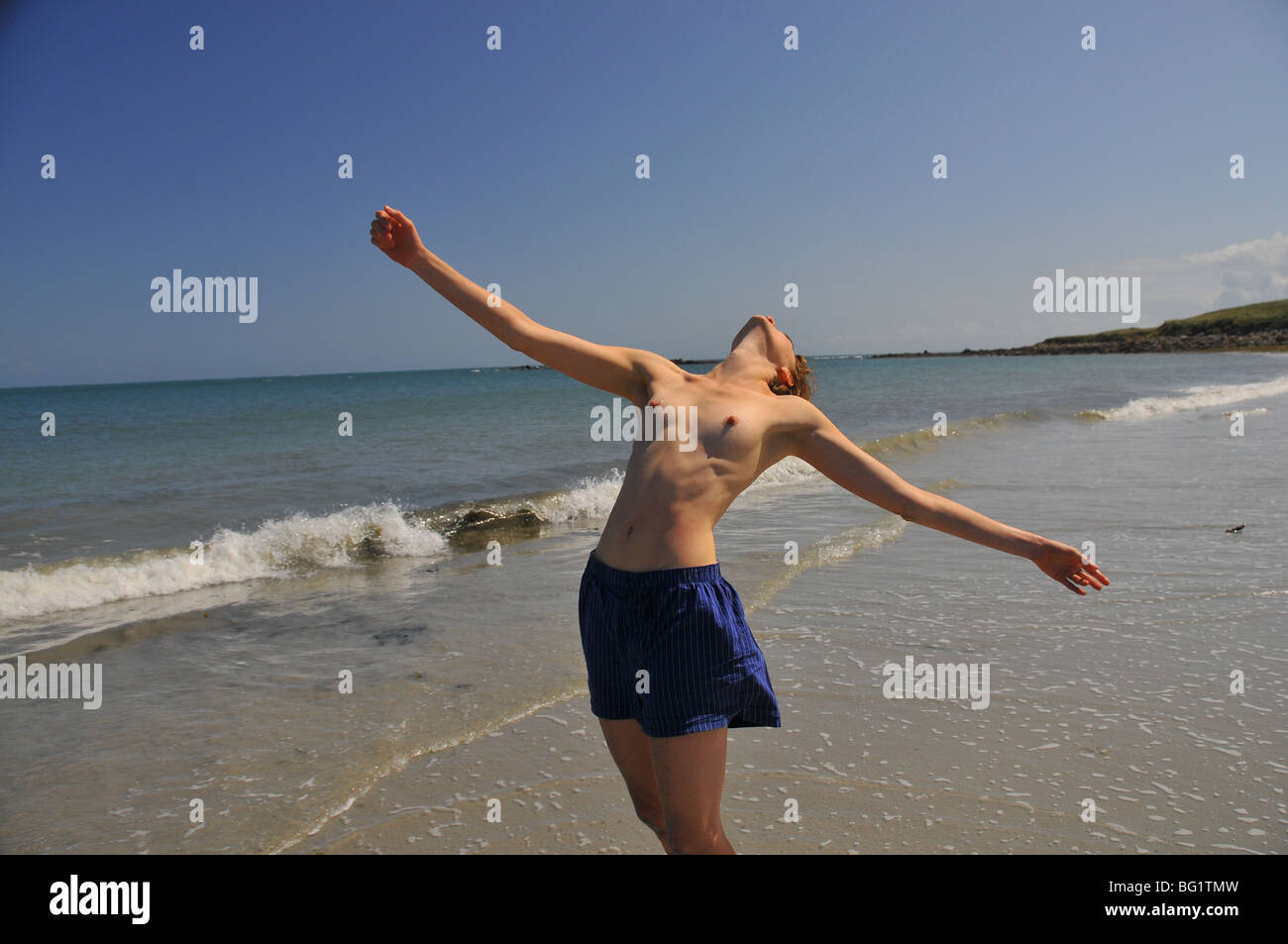 young white woman leaning back with bare breasted on the sand at the beach  Stock Photo - Alamy