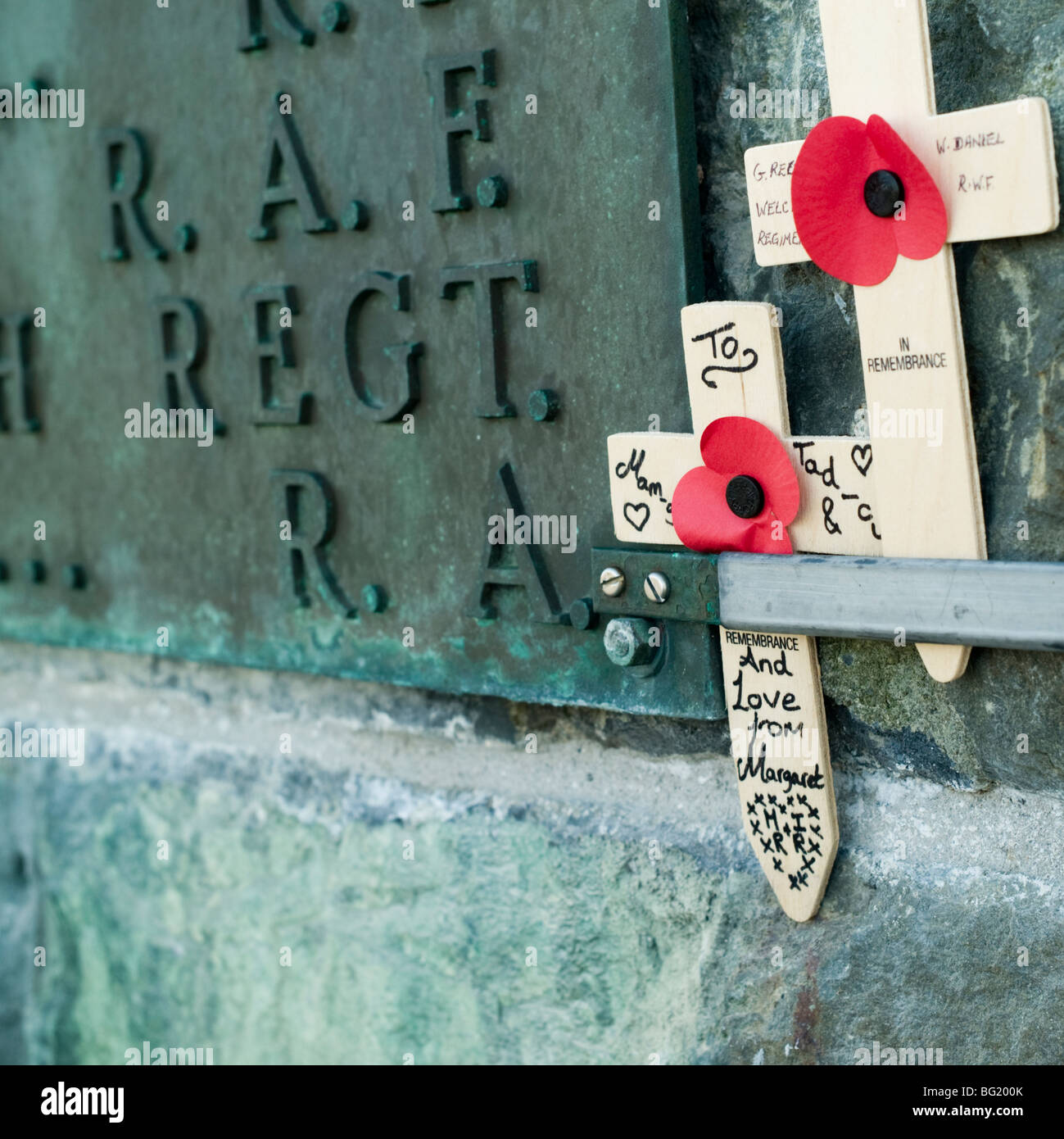 Hand written small wooden crosses on war memorial in remembrance of soldiers killed in wars, UK Stock Photo