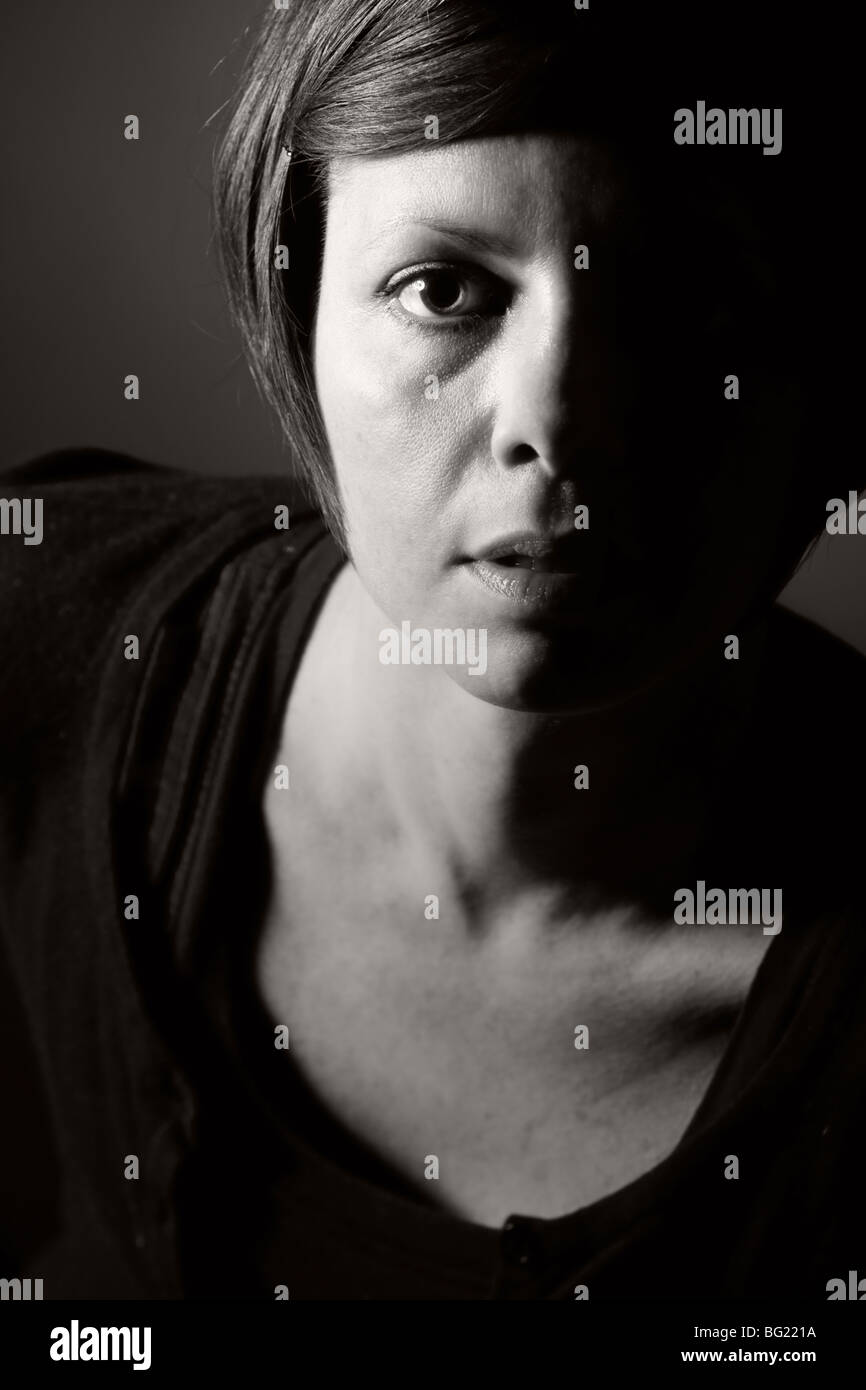 Low Key Portrait Shot of a 30s female Stock Photo