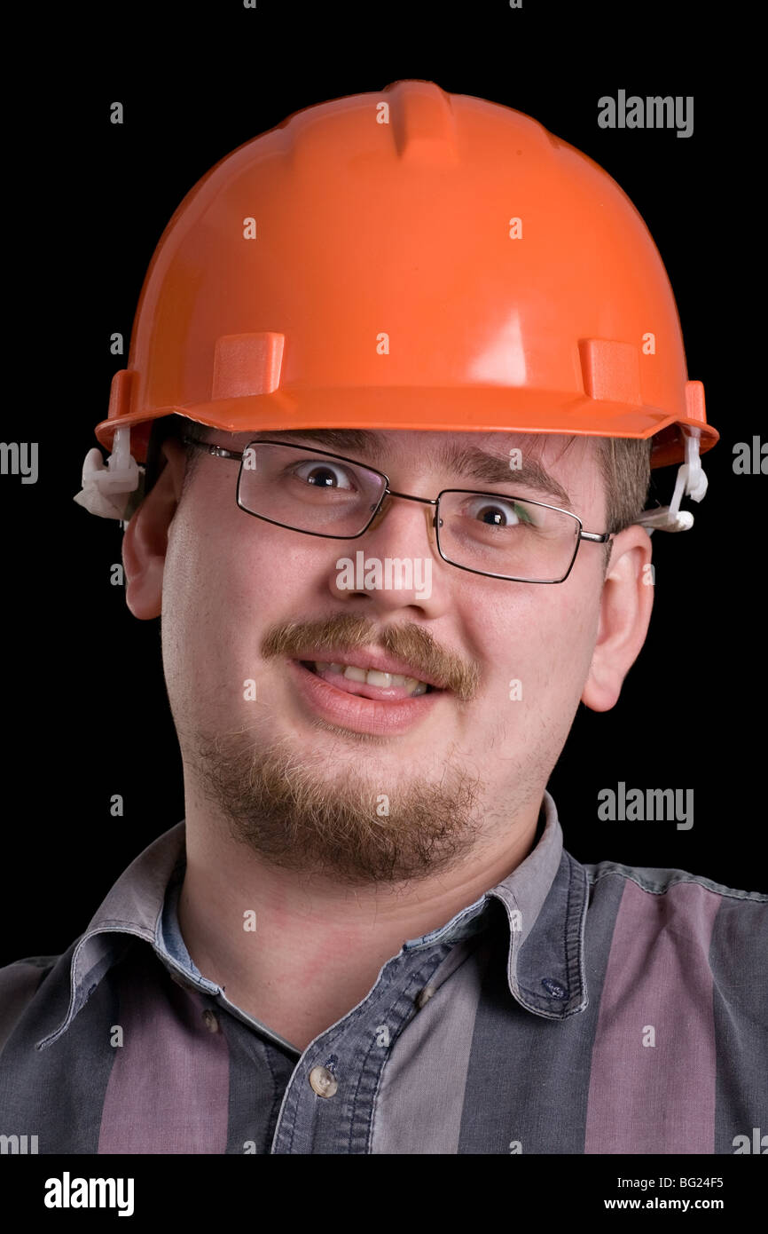 closeup portrait of man in orange hard hat, isolated on black
