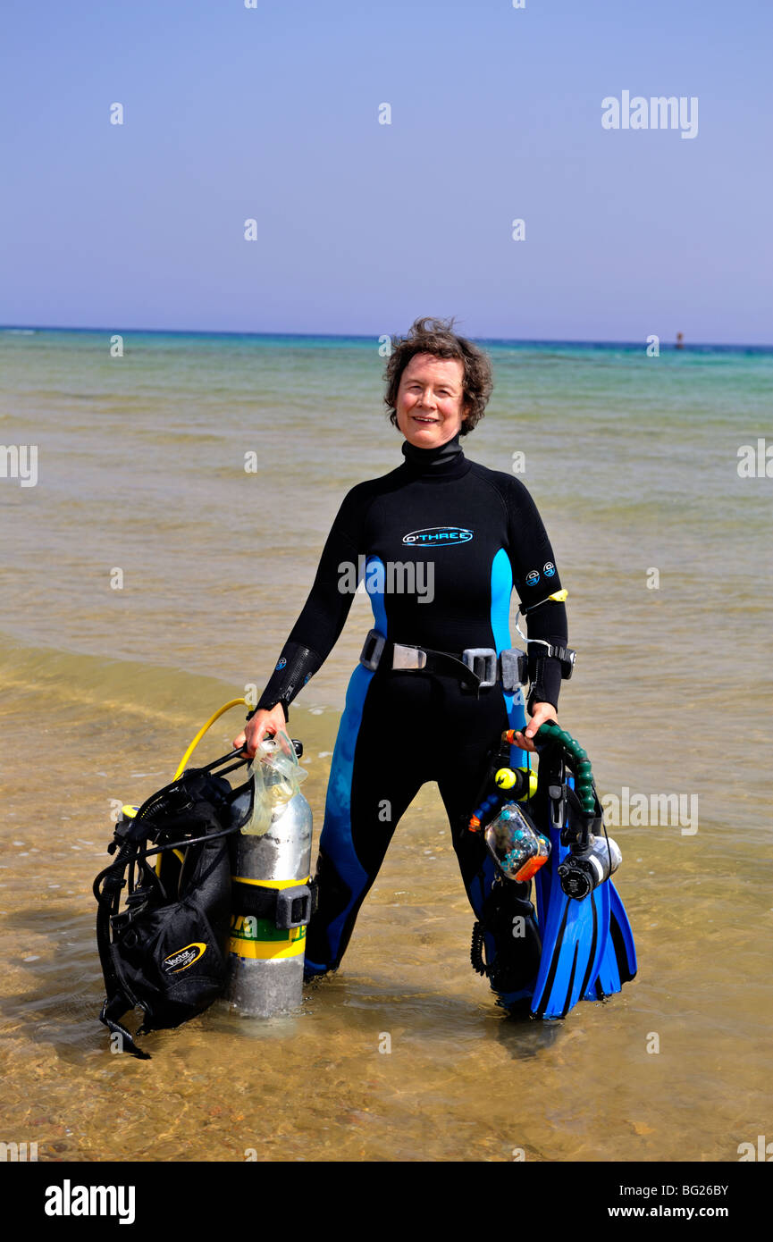 Woman scuba diver preparing for a shore dive, 'Red Sea', Egypt Stock Photo