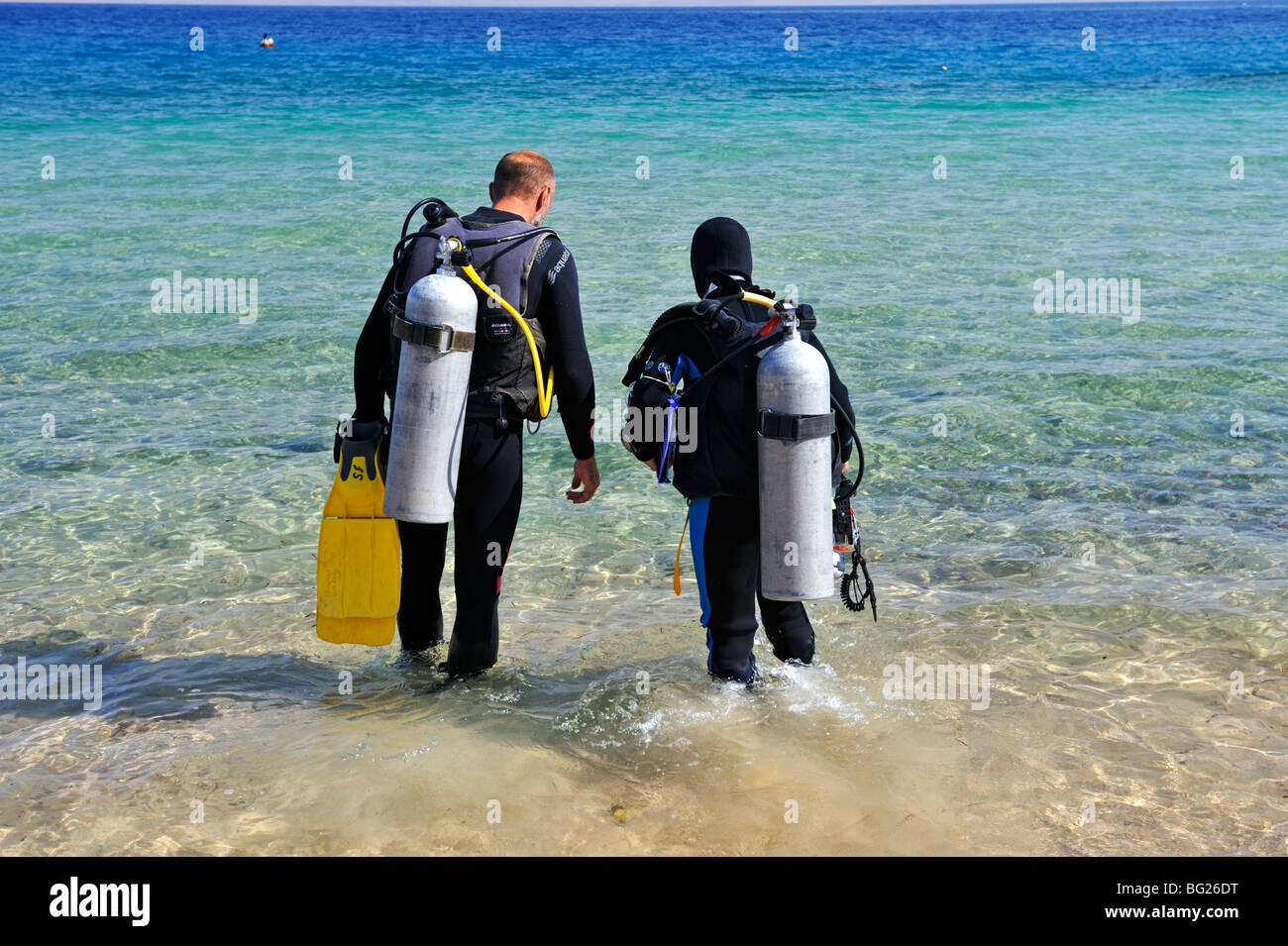 Two scuba diving walking into water for a shore dive, 'Red Sea', Egypt Stock Photo