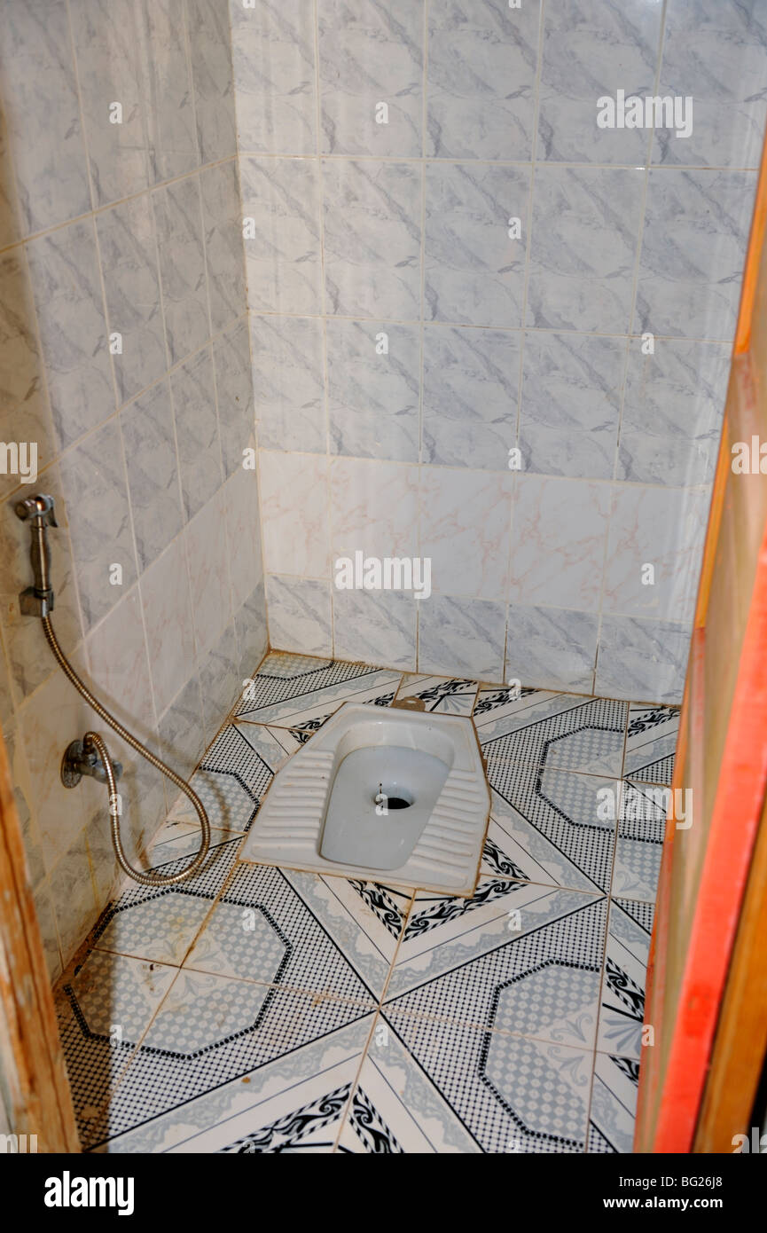 Arab Squat toilet with water hose to wash, Egypt Stock Photo
