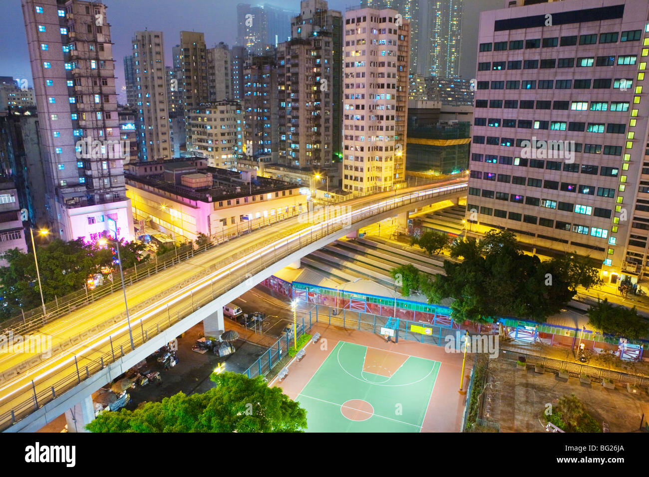 Residential apartment building exteriors, basketball court, night. China, Hong Kong Stock Photo