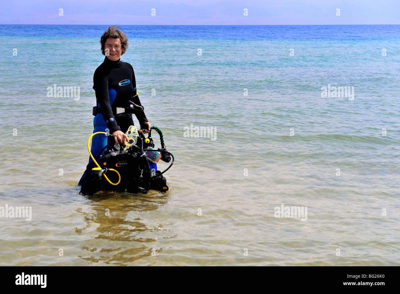 Woman scuba diver preparing for a shore dive, 'Red Sea', Egypt Stock Photo