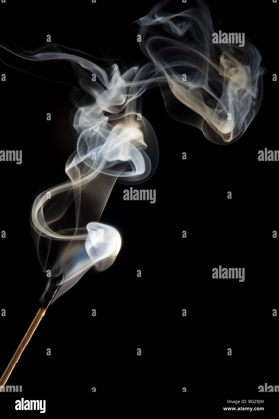 Single match stick being blown out with a wisp of smoke Stock Photo Alamy