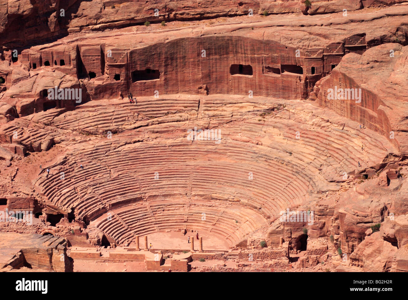 An aerial view of the Roman-era amphitheater carved into the pink sandstone at Petra, Jordan. Stock Photo